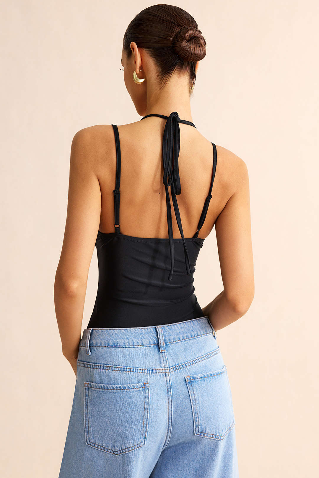 Patchwork mouwloze body met kant en strik