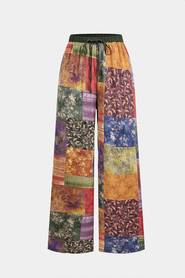 Paula - Abstracte print satijnen broek met smokwerk en wijde pijpen