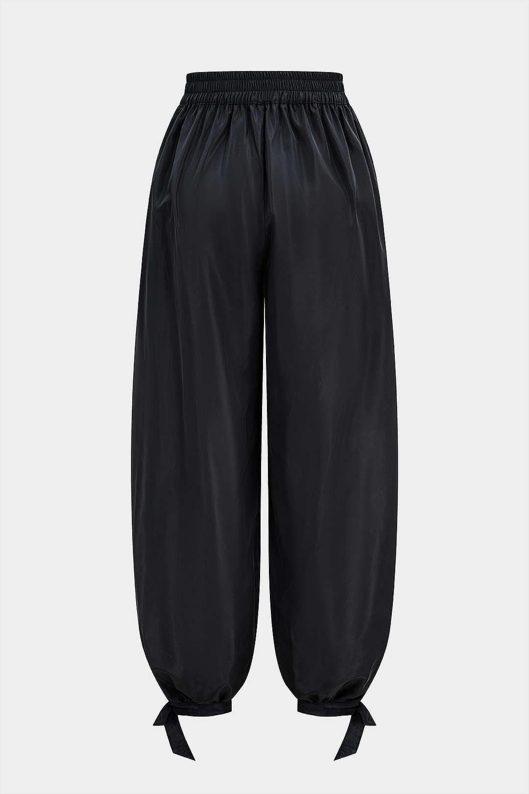 Broek met strik, smokwerk en wijde pijpen
