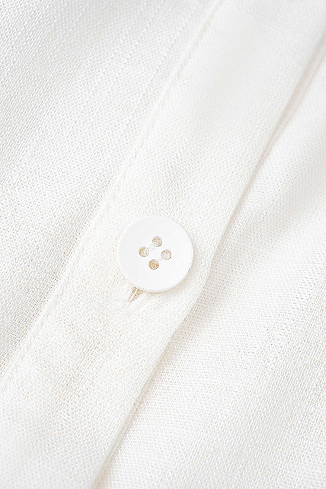 Asymmetrische mouwloze minijurk met revers en knoopjes