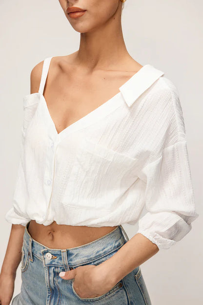 Asymmetrische mouwloze blouse met knoopsluiting en open rug