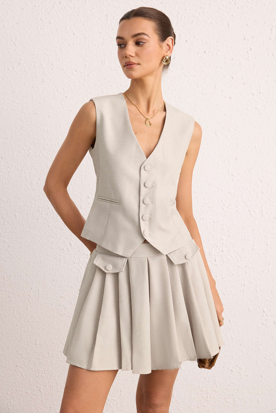 Geplooide set met gilet en rok