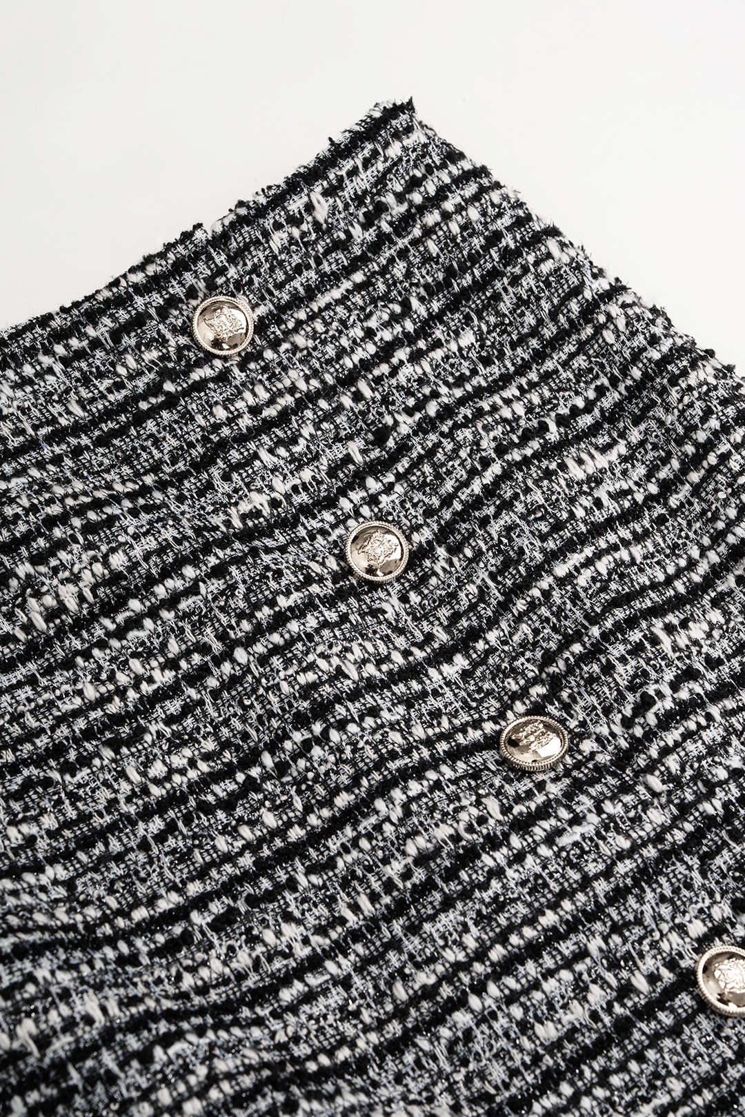 Asymmetrische metallic minirok met knoopjes en hoge taille